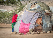 Her red shawl distinguishes this flower from her make shift home. Peering around what she calls home the women of Hargeisa are shy to the camera, ashamed to show the conditions in which they live. After taking this we printed a copy and gave it to her. A hot sweet tea later and a sit in her home left me feeling I had not dis respected this shy lady in red.